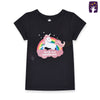 Child wearing a black t-shirt with a unicorn graphic and text on a beige background