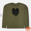 Green long-sleeve shirt with black heart design worn by a child on a white background