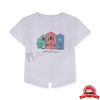 Child wearing a white t-shirt with colorful house design on a yellow background