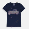 Child wearing a navy blue t-shirt with a vintage car design on a plain background