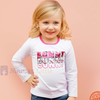 Child wearing a white long-sleeve shirt with pink text on a pink background