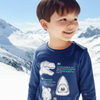 Child wearing a blue long-sleeve shirt with dinosaur graphics against a snowy mountain background