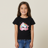 Child wearing a black t-shirt with a unicorn graphic and text on a beige background