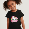 Child wearing a black t-shirt with a unicorn graphic and text on a beige background