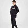 Person wearing a black tracksuit with 'Goodrich' branding on a white background