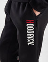 Person wearing a black tracksuit with 'Goodrich' branding on a white background