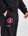 Person wearing a black tracksuit with 'Goodrich' branding on a white background