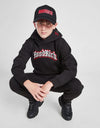 Person wearing a black 'Hood Rich' hoodie and pants with a red logo on a white background