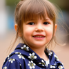 Young girl wearing a navy blue floral-patterned dress against a light background
