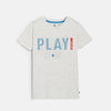 Young boy wearing a gray t-shirt with 'PLAY' printed on it against a plain background