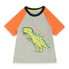 Baby wearing a gray and orange onesie with a dinosaur design on a white background