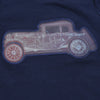 Child wearing a navy blue t-shirt with a vintage car design on a plain background