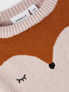 Baby wearing a pink sweater with a fox design on a white background