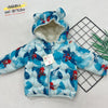 Child wearing a Spider-Man themed snow jacket in a snowy mountain setting