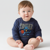 Baby wearing a navy blue sweatshirt with a graphic design on a white background