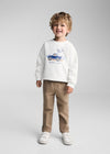 Child wearing a white sweatshirt with a blue truck graphic and text on a gray background