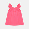 Child wearing a bright pink top with ruffled collar on a plain background